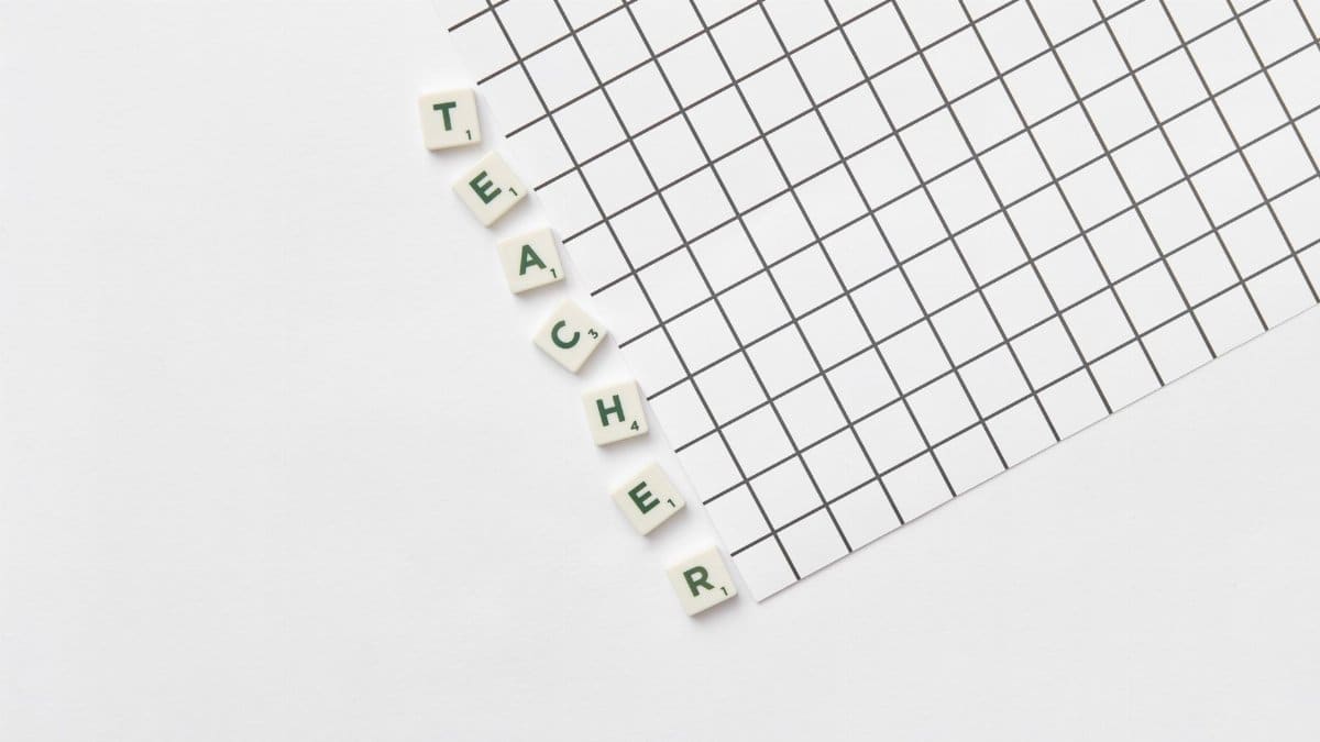 Alphabet letters spelling 'Teacher' on a white grid paper, highlighting education theme.