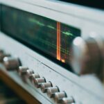 Close-up of an antique radio tuner with knobs and a retro display, evoking a classic analog feel.