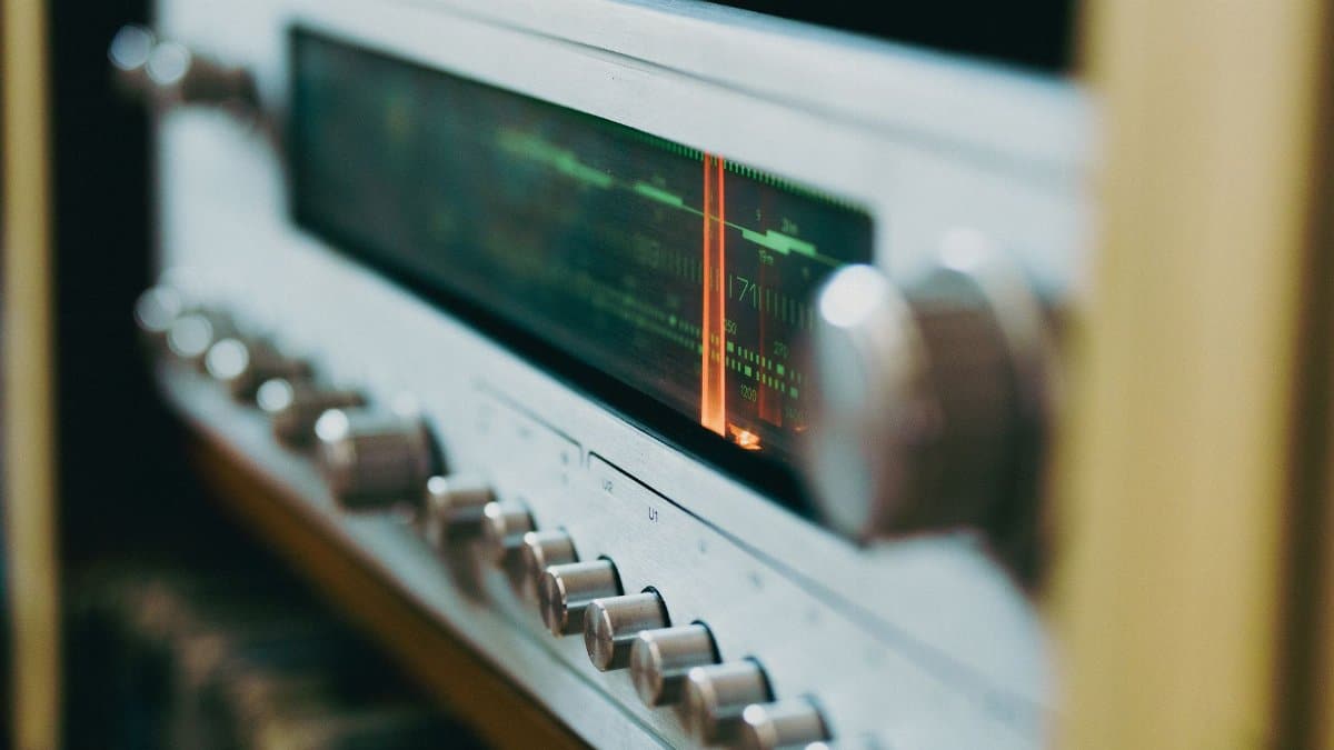 Close-up of an antique radio tuner with knobs and a retro display, evoking a classic analog feel.