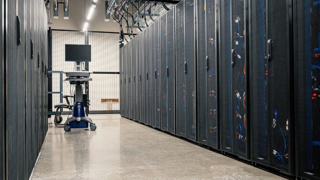 Steel framework cabinets housing servers networking devices and cables in contemporary equipped data center