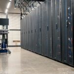Steel framework cabinets housing servers networking devices and cables in contemporary equipped data center