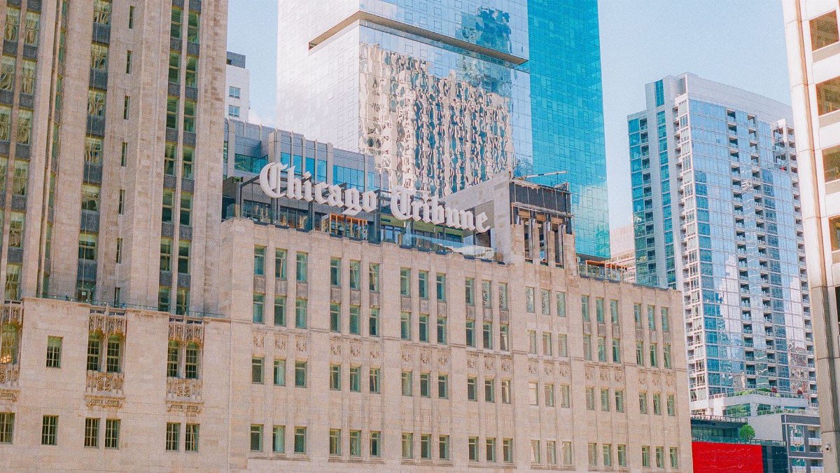 A view of the iconic Chicago Tribune Tower amidst modern skyscrapers in downtown Chicago.