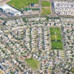 Discover this expansive suburban neighborhood from above, showcasing modern residential planning.