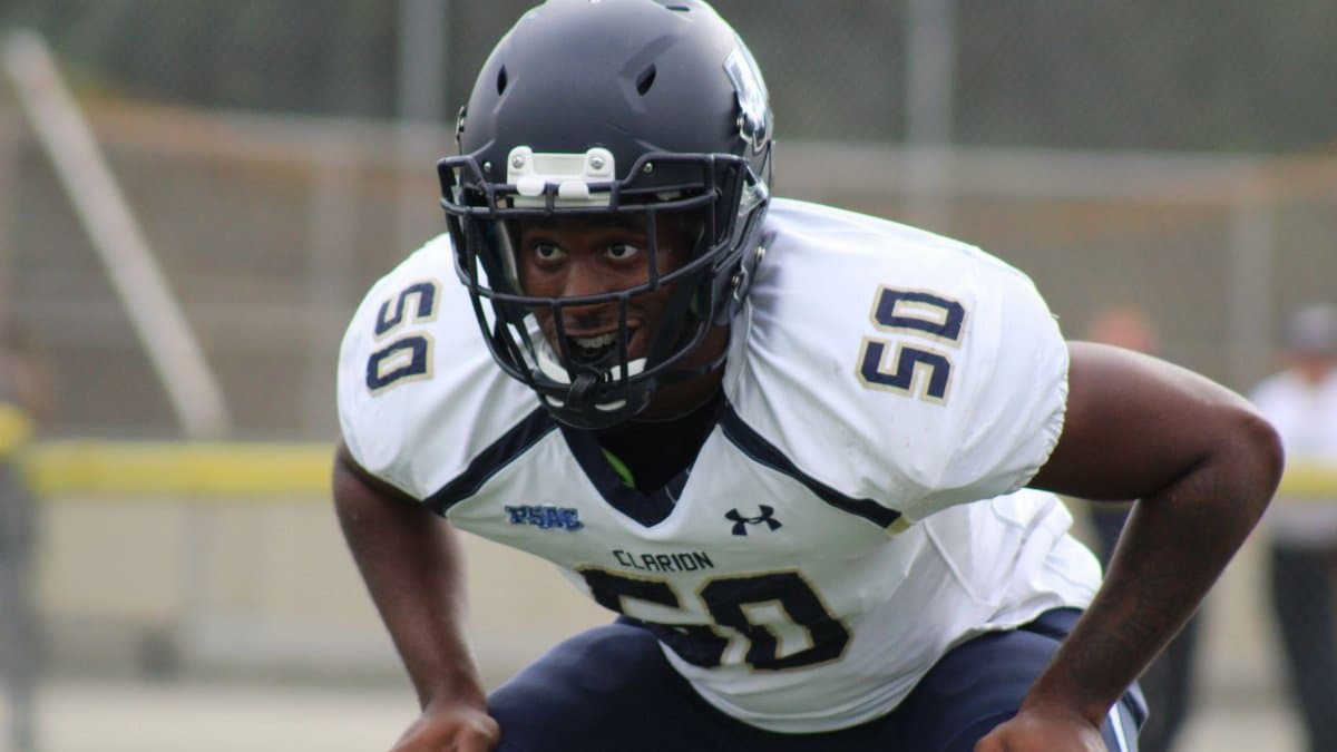 American football player in uniform ready for action on the field.
