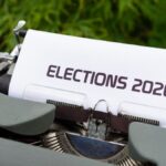Close-up of a typewriter typing 'Elections 2020' outdoors.