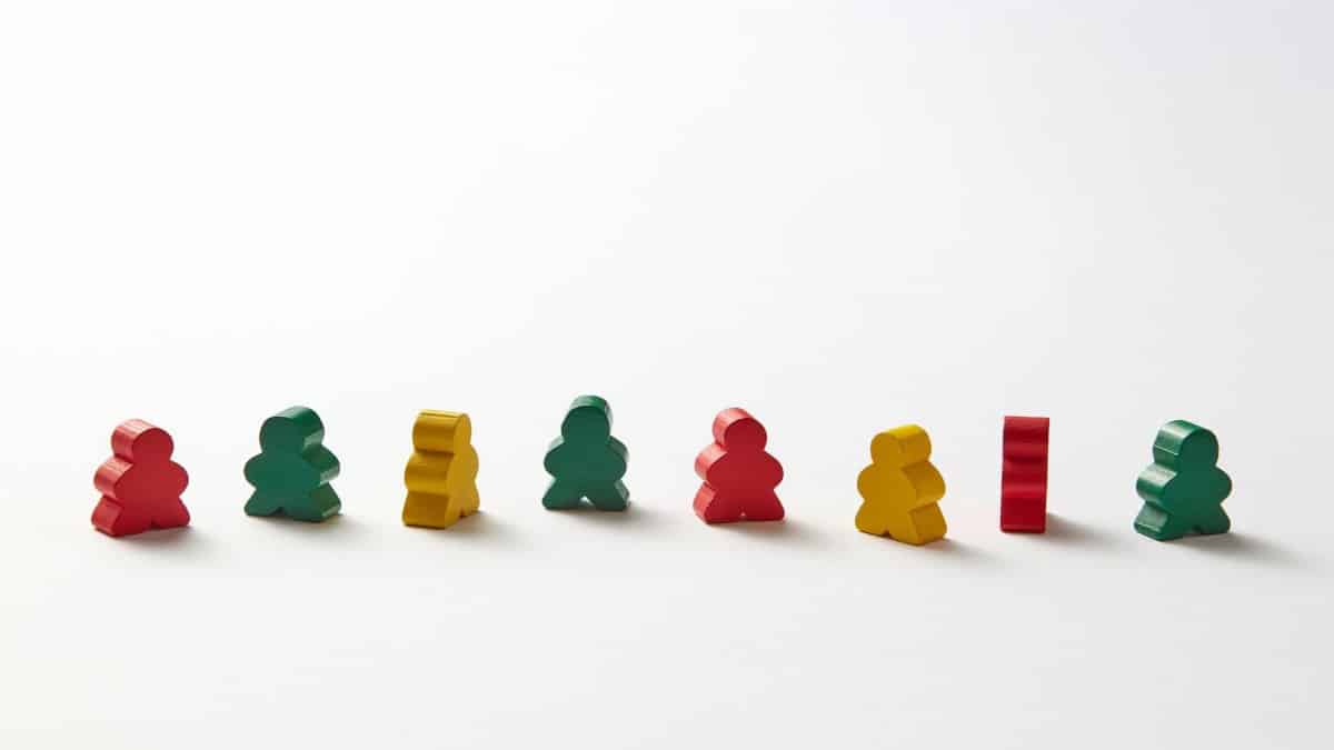 An arrangement of colorful wooden game pieces against a white background, ideal for play concepts.