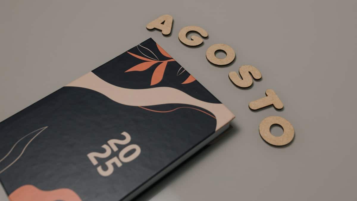 A stylish 2025 planner alongside wooden letters spelling 'August'. Perfect for organization themes.
