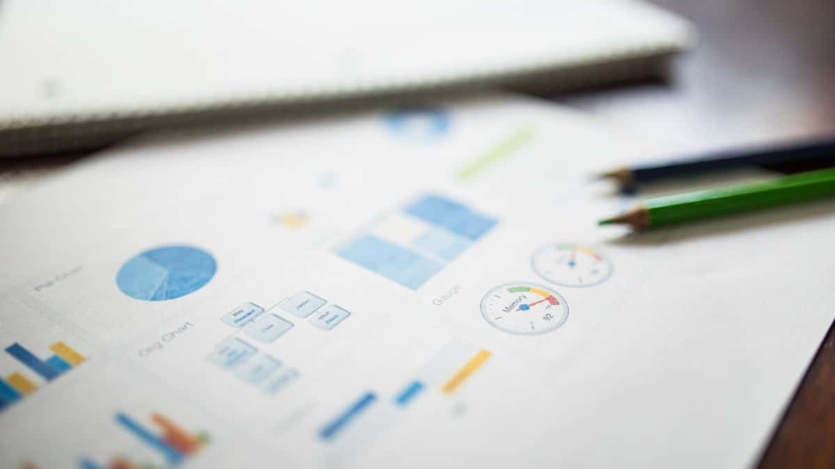 Illustration of a business financial report featuring various charts and graphs on paper.