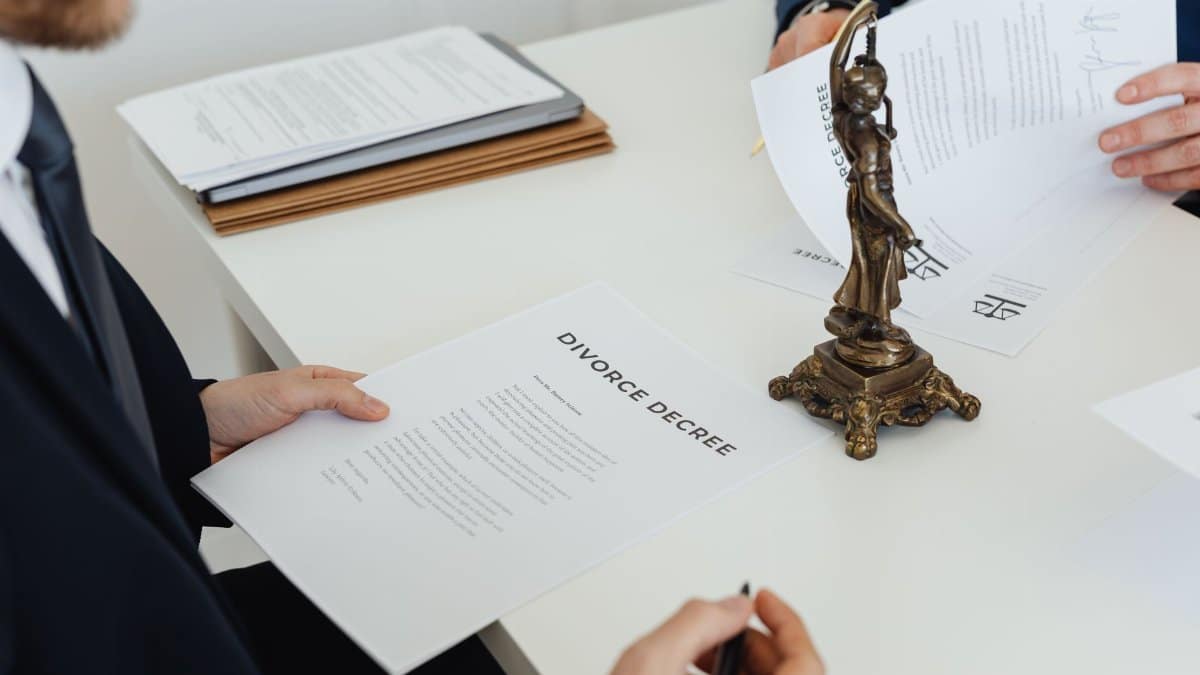 Two professionals discuss divorce decree documents, focusing on legal negotiations.