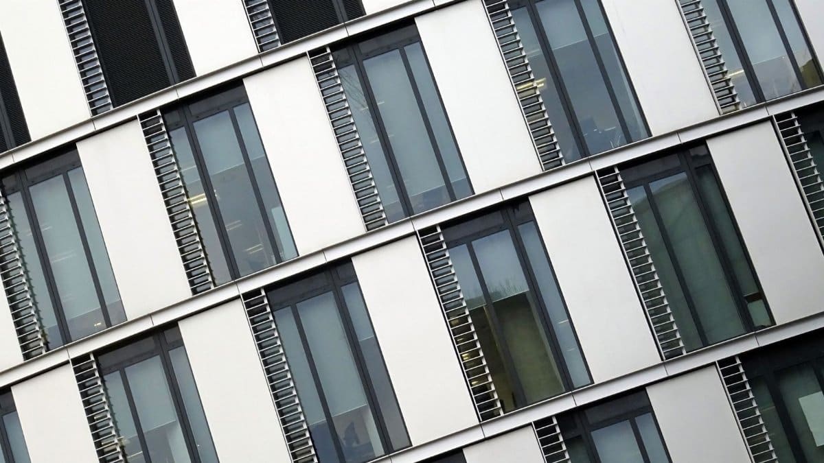 Angled view of a modern office building with large glass windows and steel accents.
