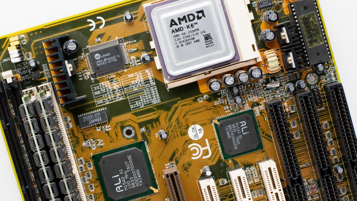Close-up of a vintage AMD K6 CPU on a retro motherboard showing intricate electronic details.