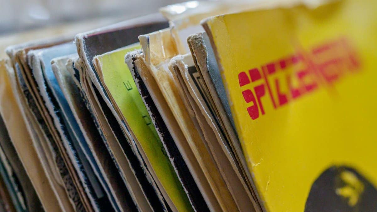 Colorful vintage vinyl record sleeves stacked together with a blurred background.