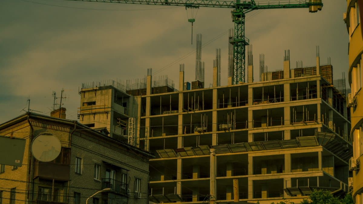 A crane over a modern building under construction in Dnipro, Ukraine.