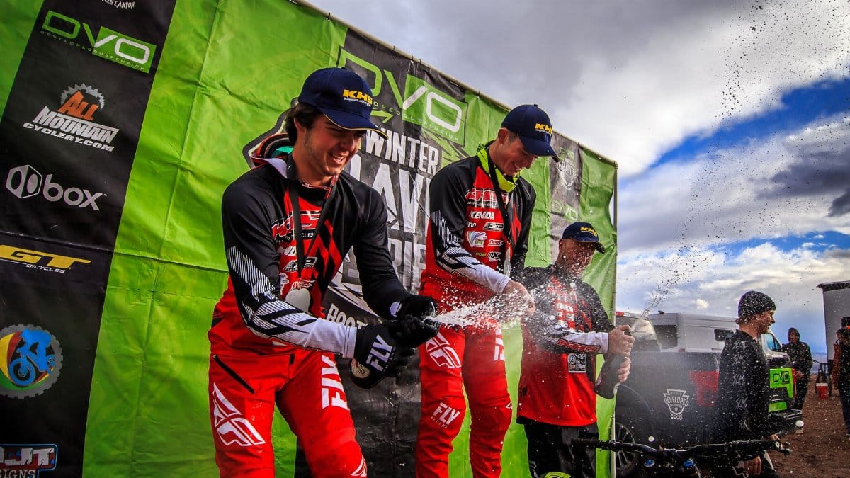 Winners celebrate with champagne on the podium at a motocross event in Boulder City, NV.