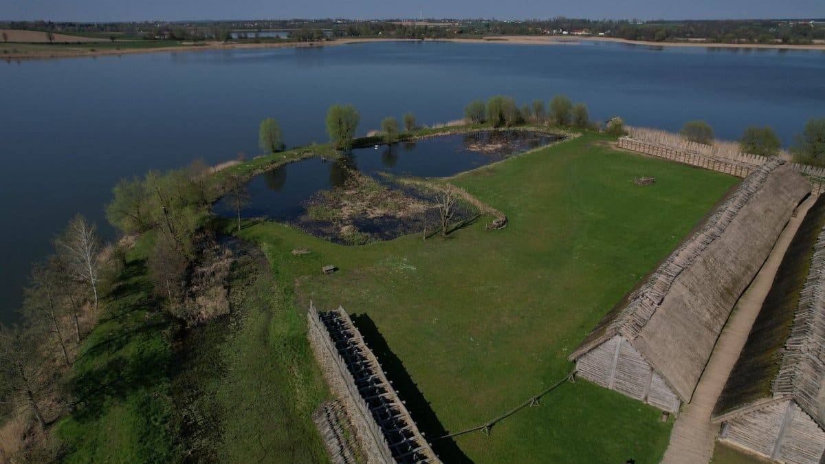 Aerial shot of the ancient Biskupin settlement in Poland, showcasing the open-air museum and surrounding landscape.