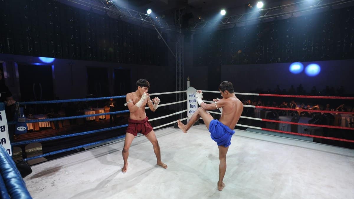 Two Muay Thai fighters engage in an intense match in Pattaya City, Thailand.