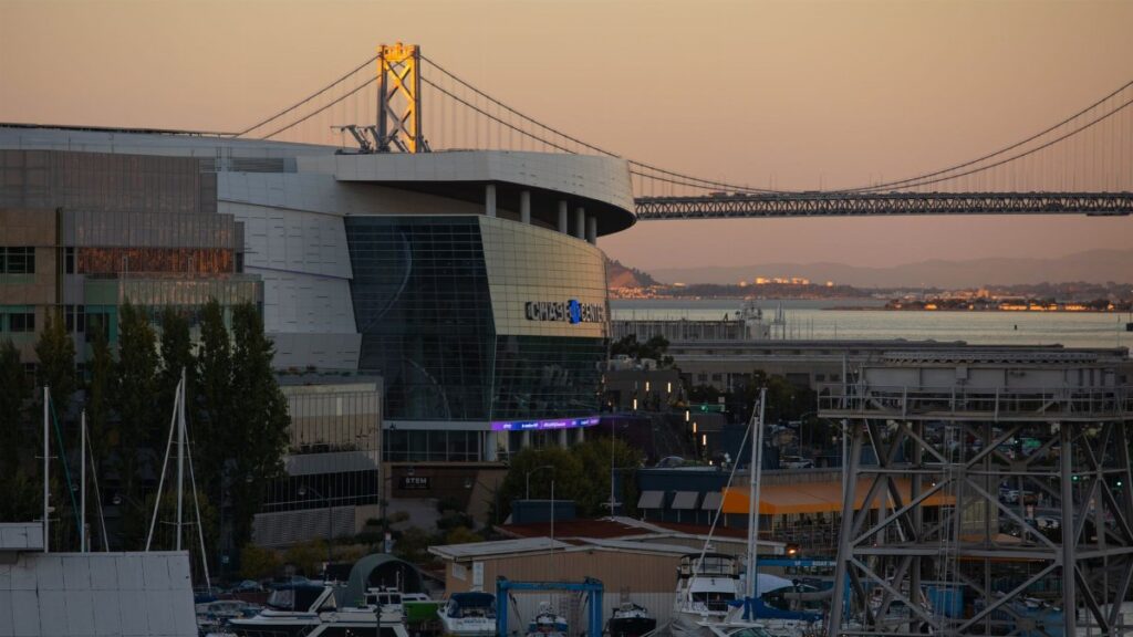 Stunning view of Chase Center and Bay Bridge during golden hour in San Francisco.