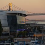 Stunning view of Chase Center and Bay Bridge during golden hour in San Francisco.