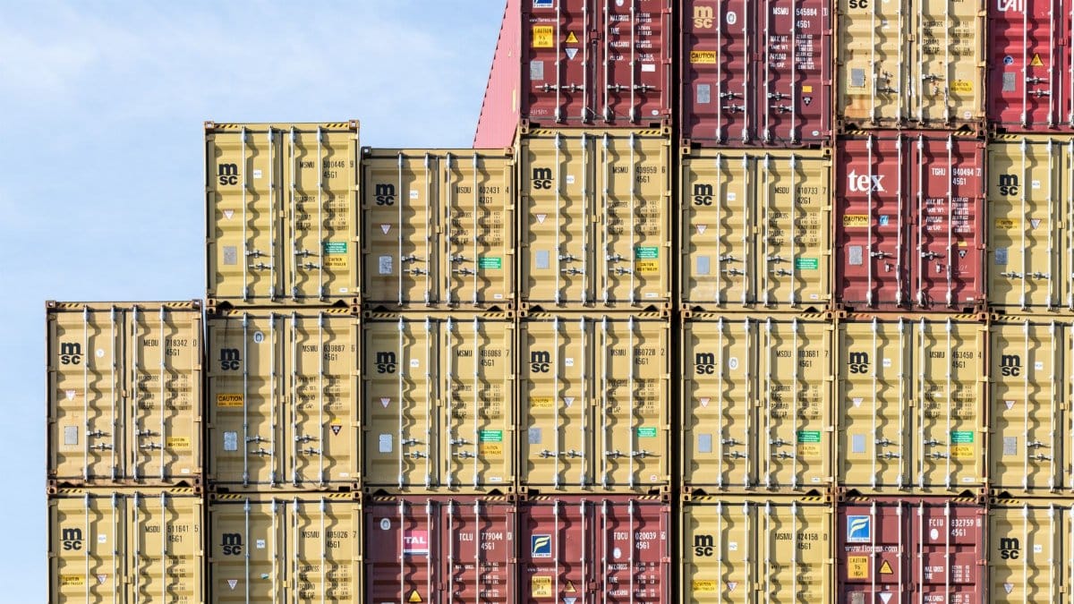 Colorful stacked shipping containers at Hamburg port, showcasing global trade and logistics.