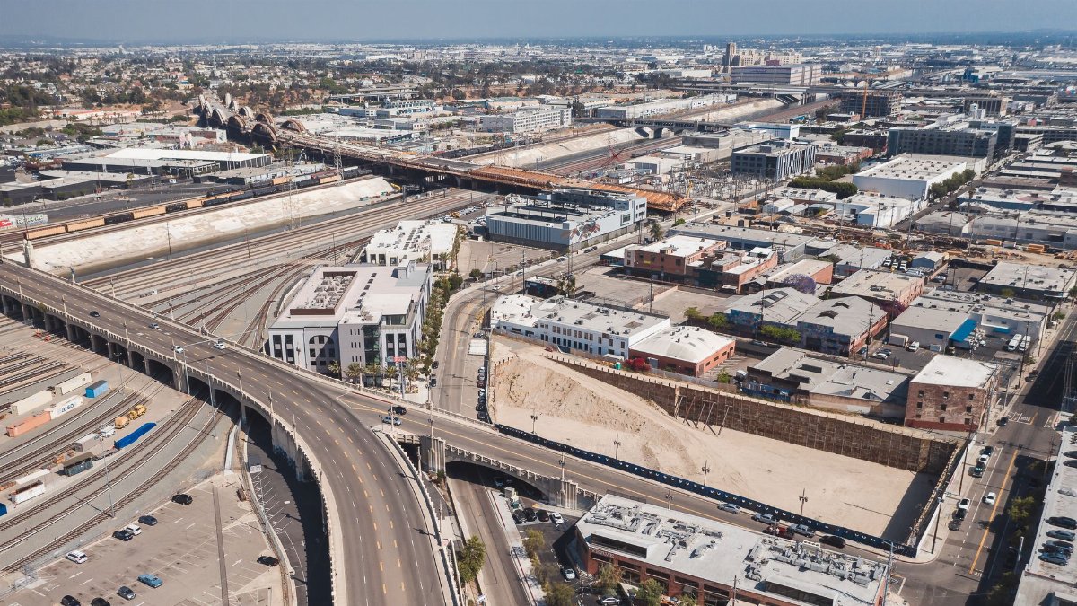 High-angle view of a sprawling urban landscape with highways and train tracks.