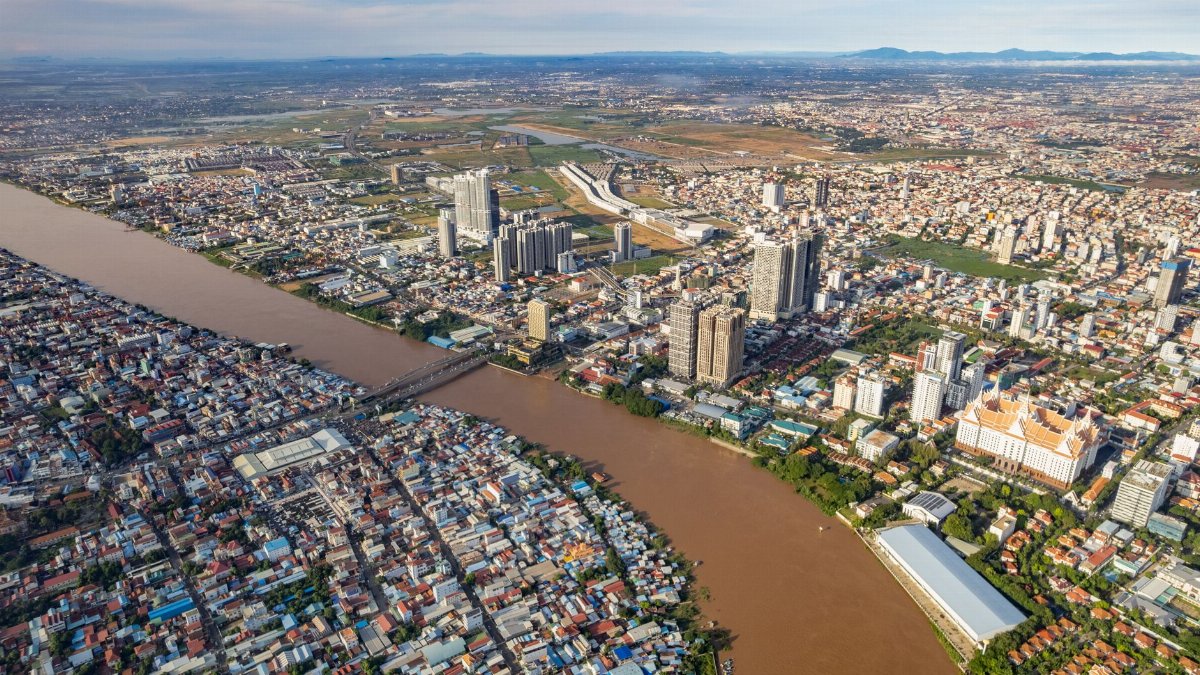 A stunning aerial view of Phnom Penh, showcasing the urban landscape and river in Cambodia.