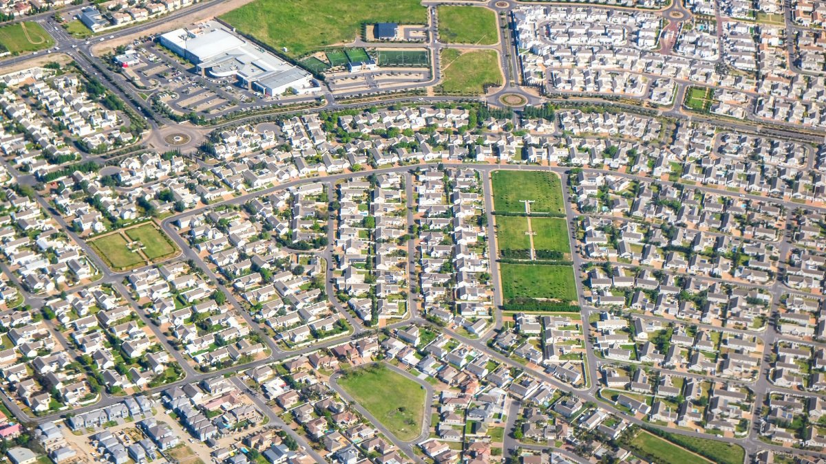 Discover this expansive suburban neighborhood from above, showcasing modern residential planning.