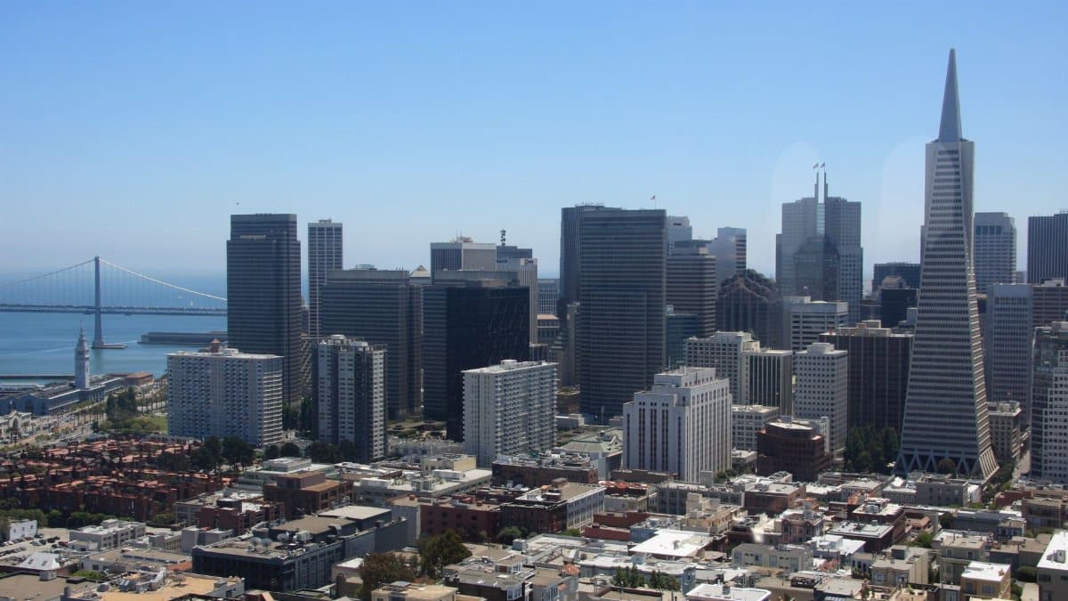 Aerial view of San Francisco skyline, featuring the iconic Transamerica Pyramid and Bay Bridge.