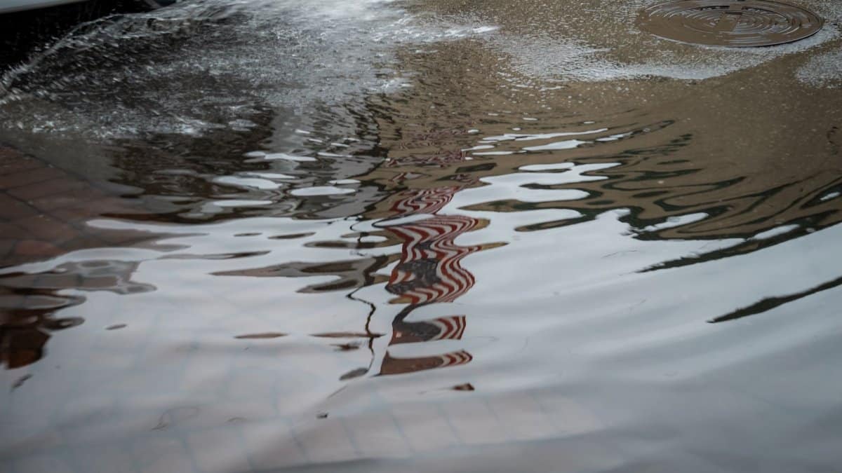 Flooded street with water reflections in Savannah, Georgia. Urban rain aftermath.