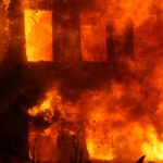 Dramatic scene of a building engulfed in flames, showcasing the power and danger of fire.