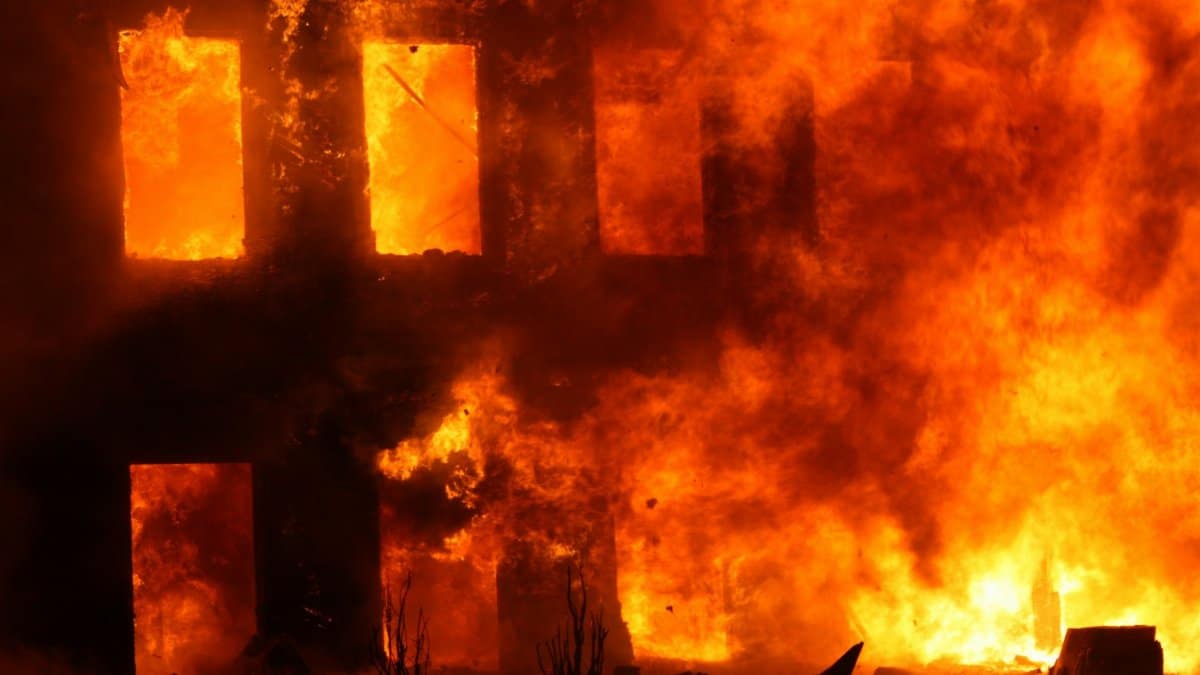 Dramatic scene of a building engulfed in flames, showcasing the power and danger of fire.
