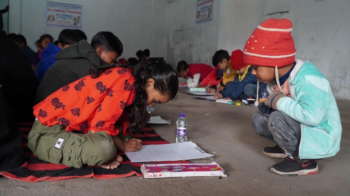 A group of children participating in a drawing session indoors, showcasing creativity and learning.