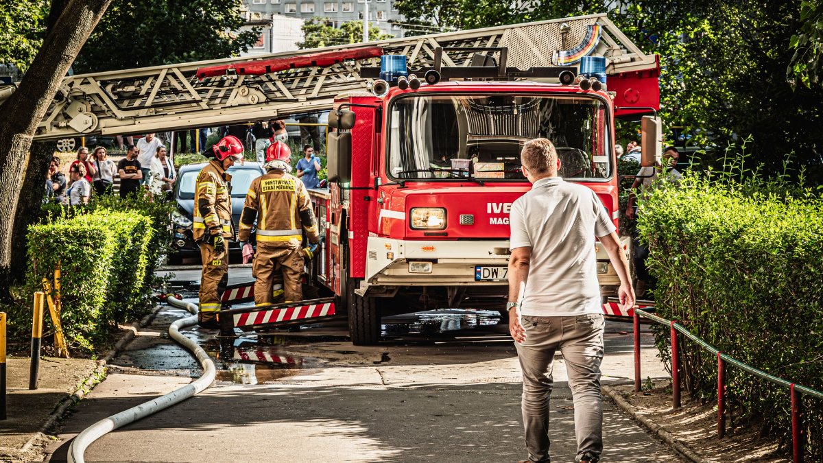 Firefighters and fire truck responding to an emergency in Wrocław, Poland.