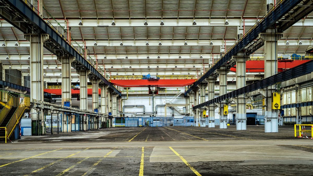Expansive industrial warehouse interior showcasing steel framework and spacious layout for diverse manufacturing needs.