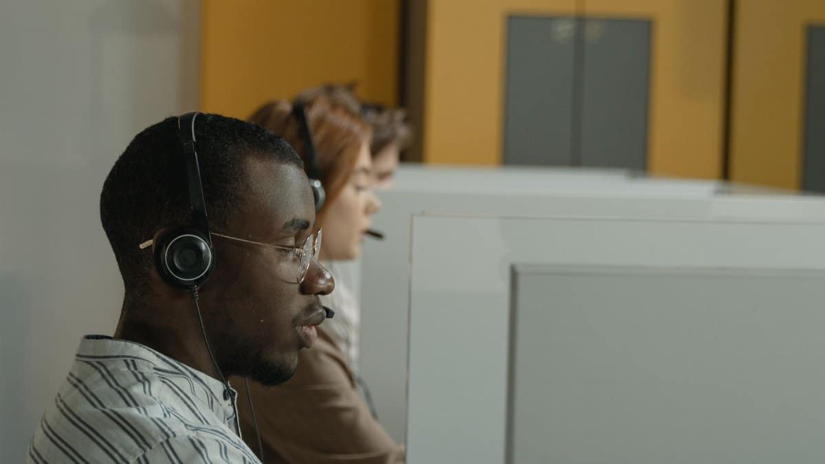 Professional call center agents working in a modern office environment, emphasizing teamwork and customer support.