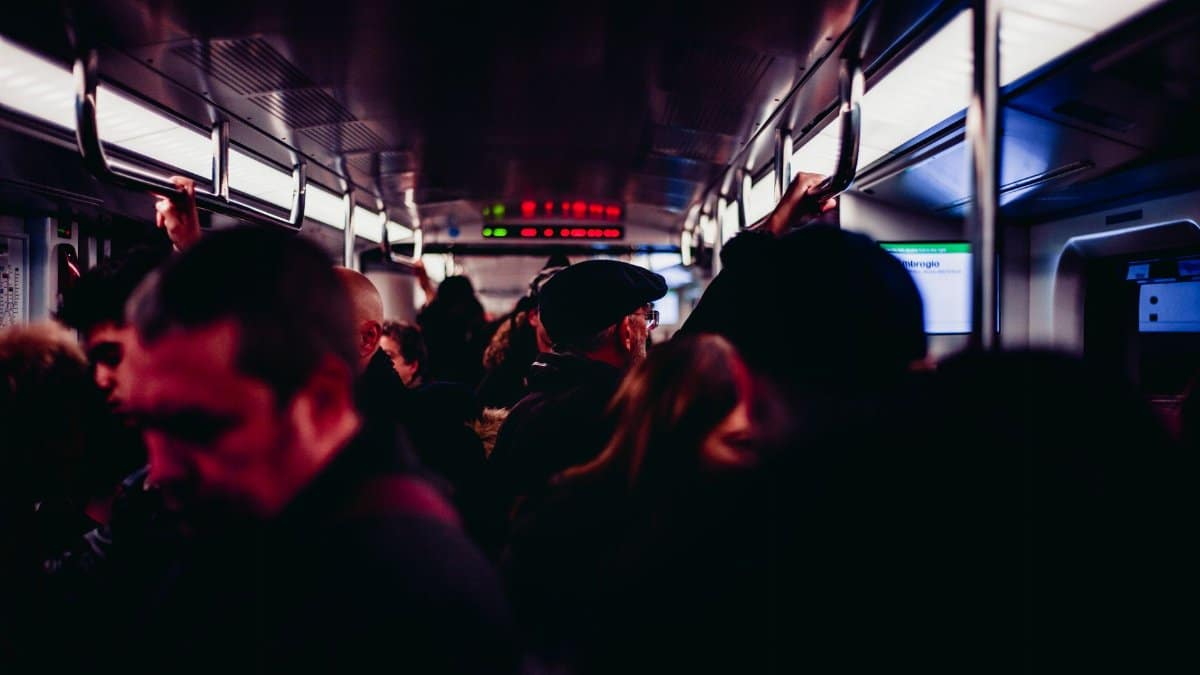 Passengers on a busy metro train in Milan, showcasing urban commuting life.