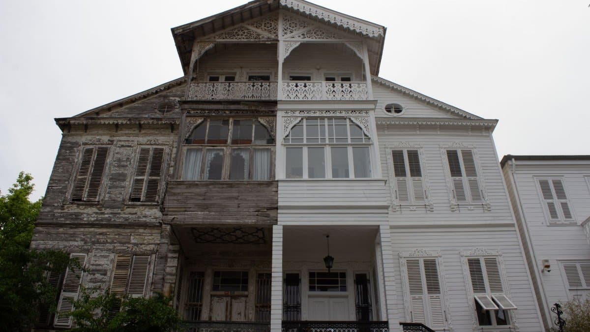 Intricately designed facade of a historic wooden house showcasing classic architectural elements.
