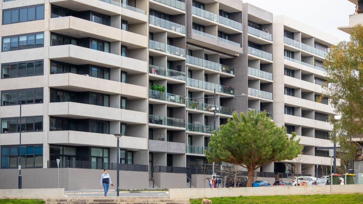 Spacious urban apartment building featuring multiple balconies and a modern architectural design.