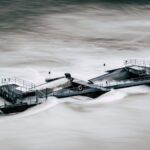 An aerial view of a structure overwhelmed by a river flood in Bern, Switzerland.