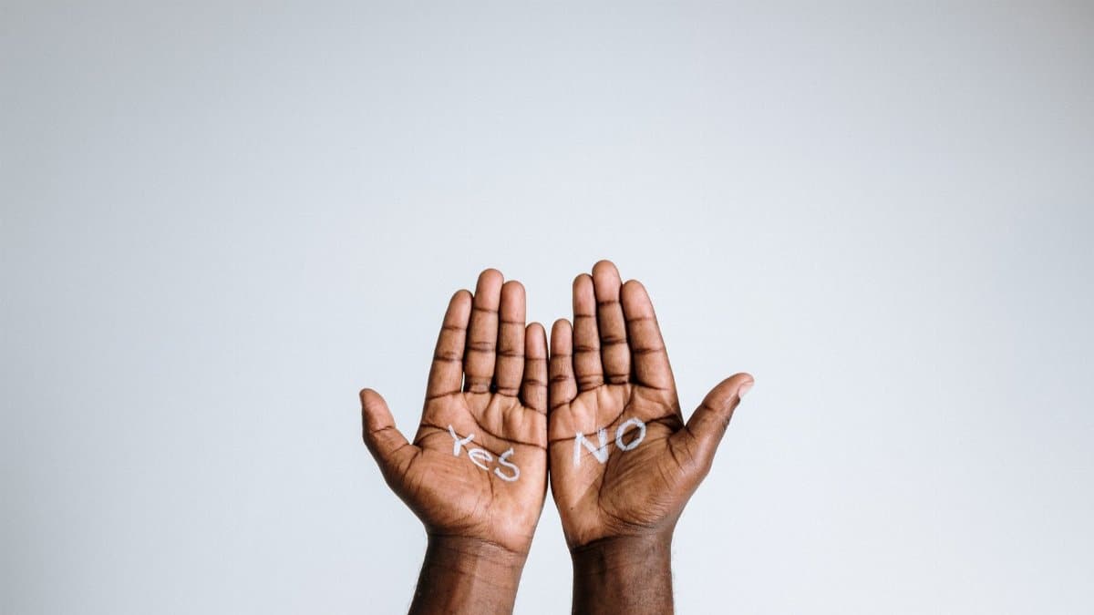 Photo of open hands with 'Yes' and 'No' written on the palms, expressing choice and diversity.