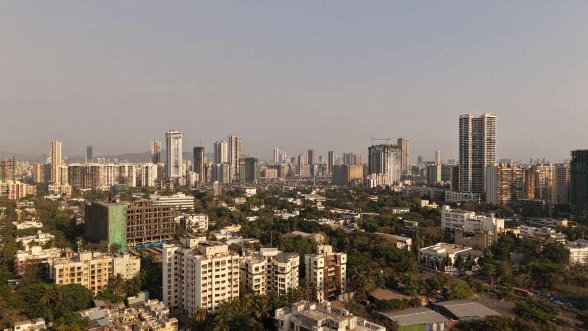 A breathtaking aerial view of Mumbai's modern skyline during the day with clear skies.