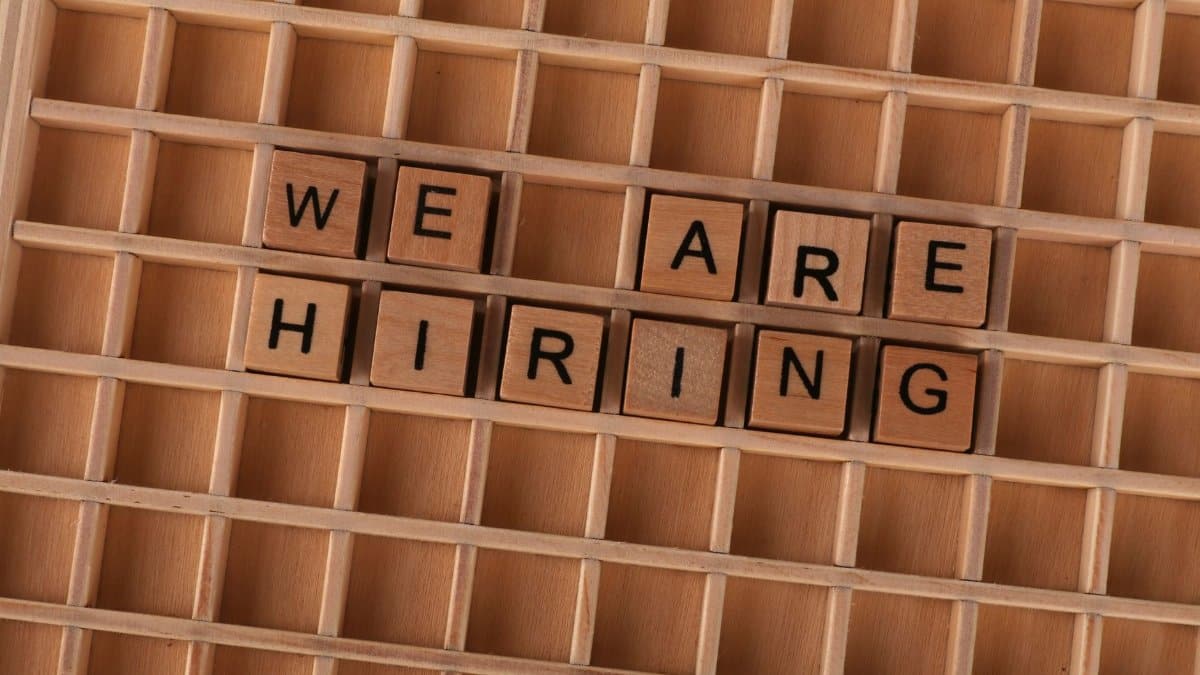 Wooden tiles on a board forming the phrase 'We Are Hiring', ideal for job announcements.