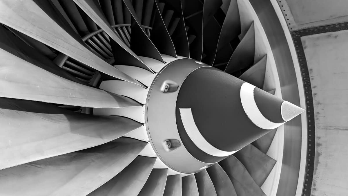 Detailed black and white photograph of aircraft turbine engine blades showcasing engineering precision.