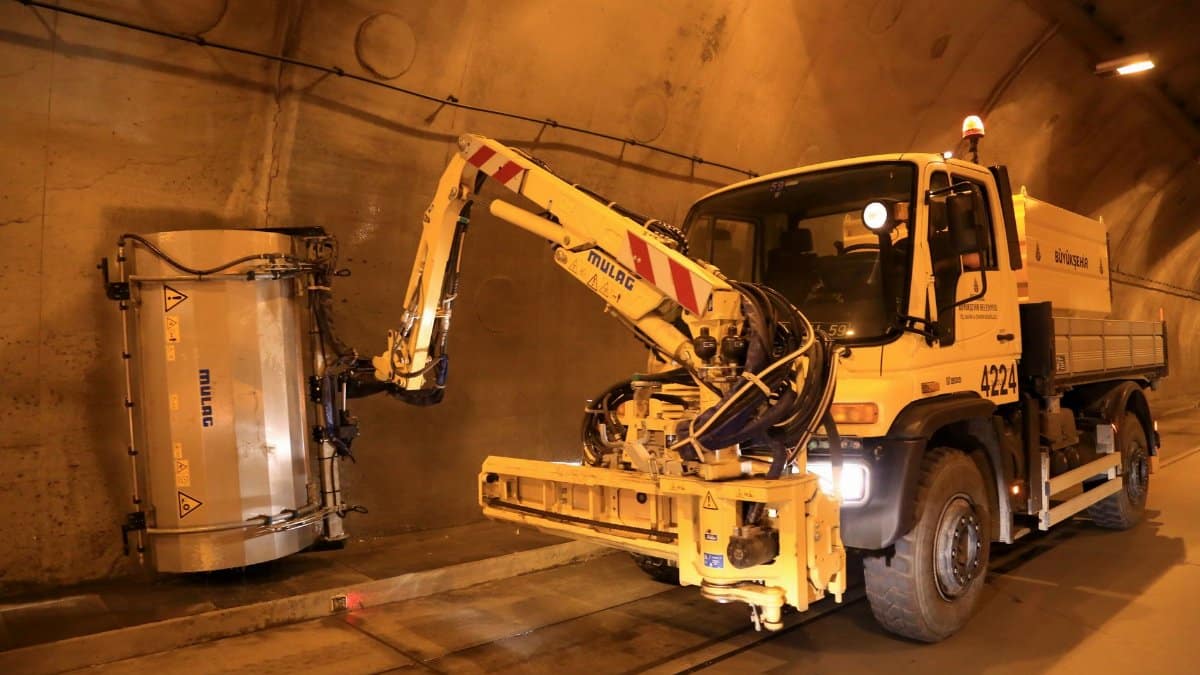 Heavy-duty vehicle operating in a tunnel, showcasing industrial construction and engineering.