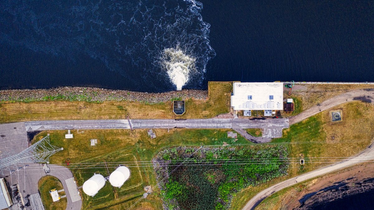 Aerial shot of a power plant with water discharge into a river in Alma, Wisconsin.