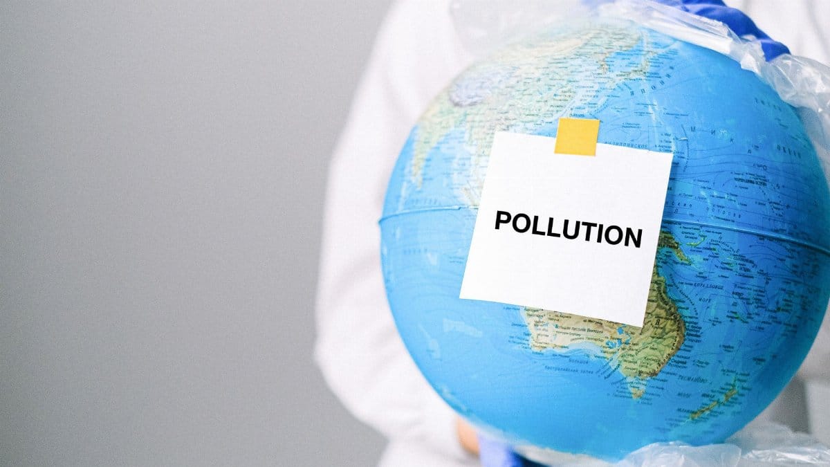 Globe wrapped in plastic highlighting pollution and environmental concerns.