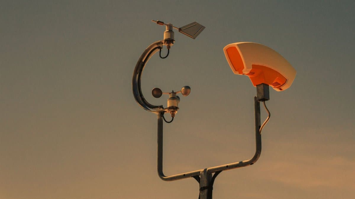 Weather monitoring equipment with a sunset sky backdrop, highlighting technology and atmosphere.