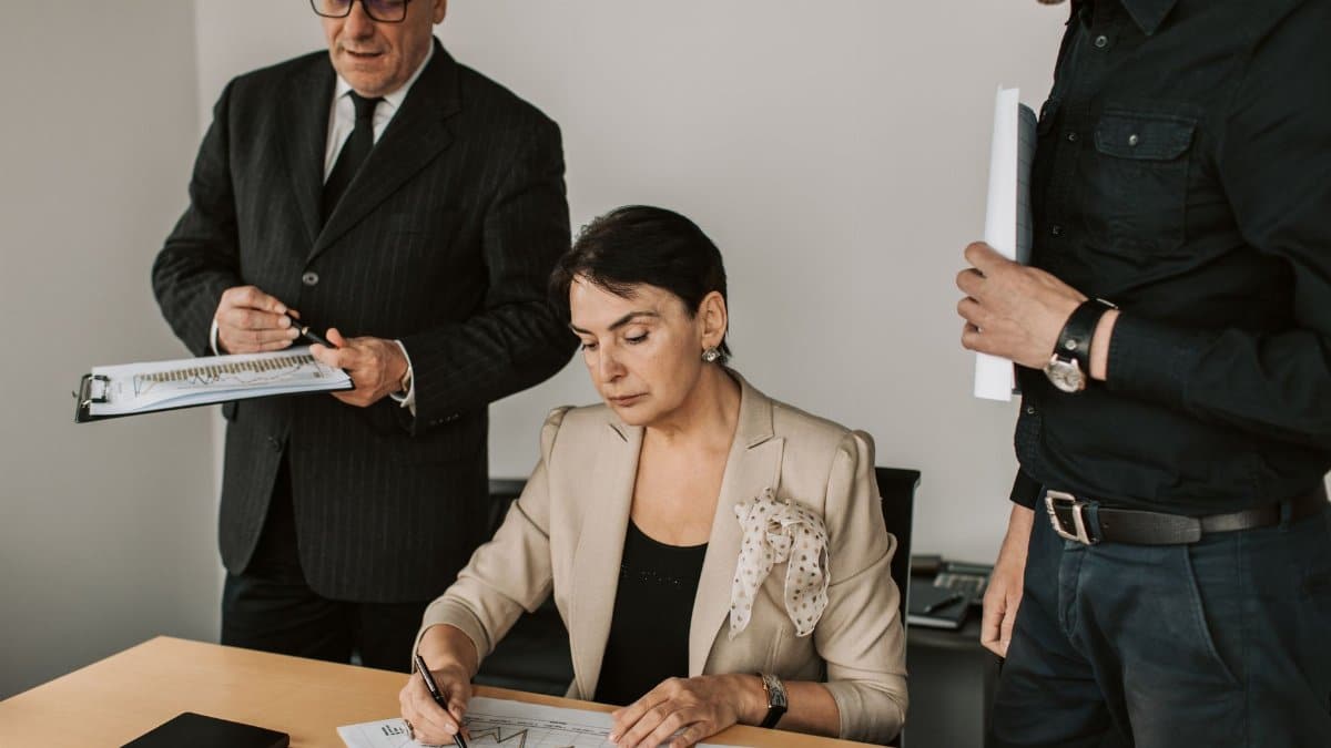 Business professionals collaborating on financial documents in an office setting.