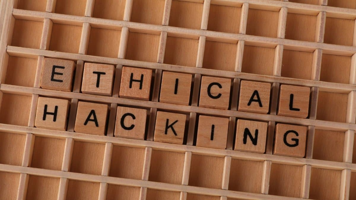 Wooden blocks spell 'ethical hacking', symbolizing cybersecurity concepts.