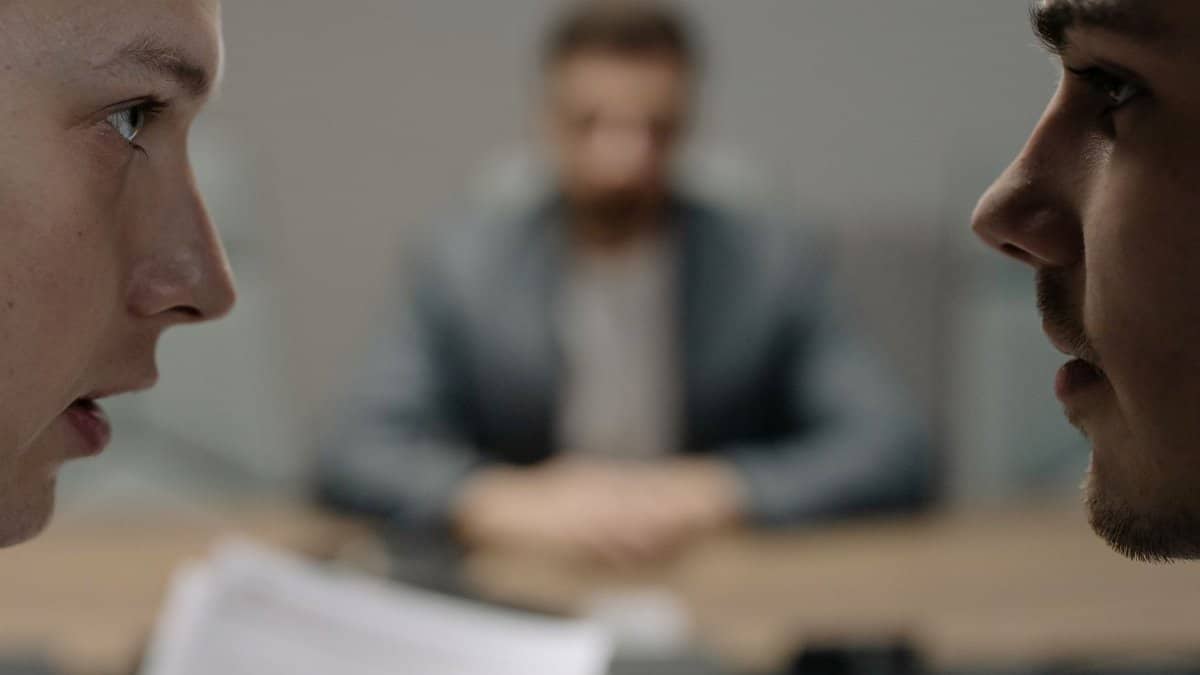 Close-up of two men in a serious discussion at a business meeting.