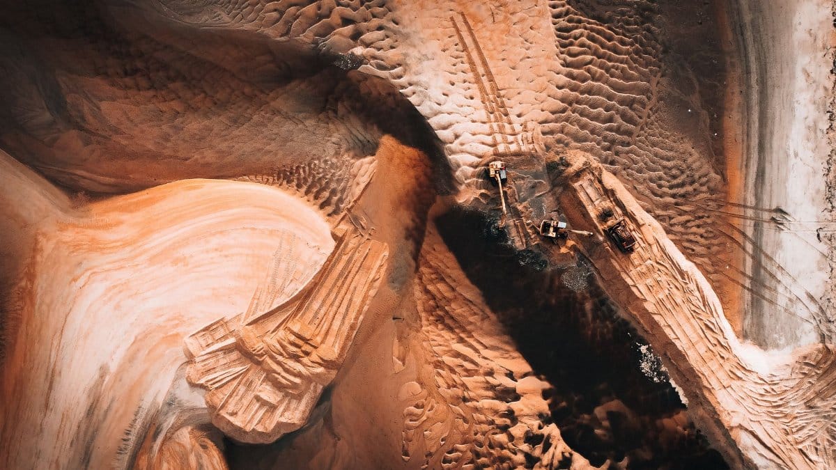Stunning aerial shot of sand mining extraction in dynamic landscape.